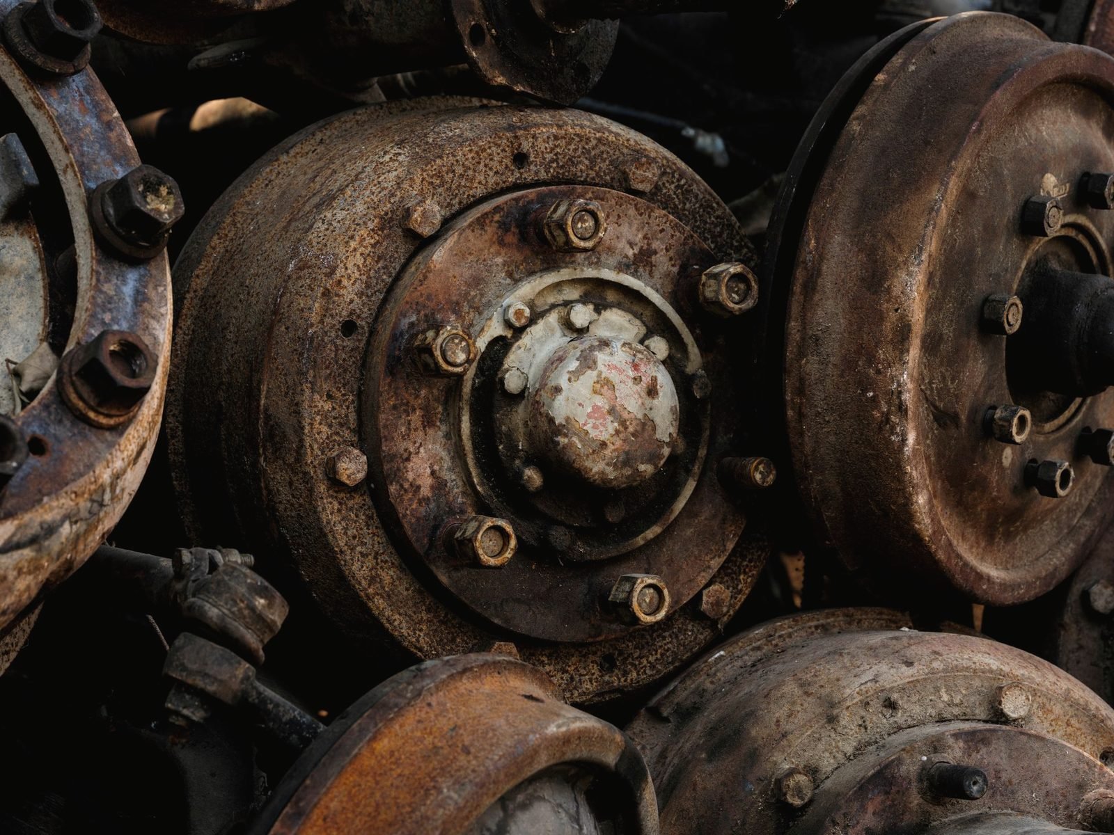 A pile of rusted brake drums and hubs